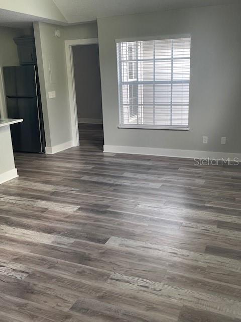 12149 Armenia Gables Circle, Unit 12149 Tampa, FL 33612 - Photo 22 of 27 an empty room with wooden floor and windows