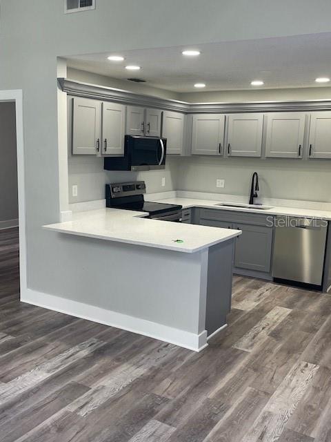 12149 Armenia Gables Circle, Unit 12149 Tampa, FL 33612 - Photo 23 of 27 a kitchen with stainless steel appliances granite countertop a sink a stove and a refrigerator