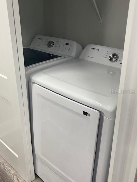 12149 Armenia Gables Circle, Unit 12149 Tampa, FL 33612 - Photo 8 of 27 a utility room with dryer and washer