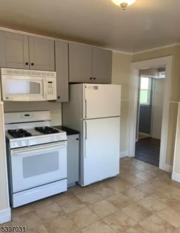 a kitchen with cabinets and white stainless steel appliances