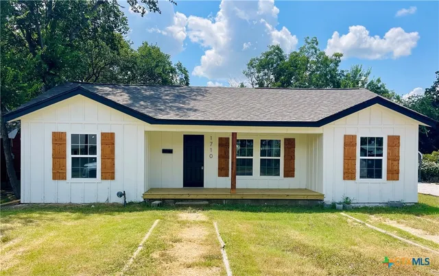 a view of a house with pool and garden
