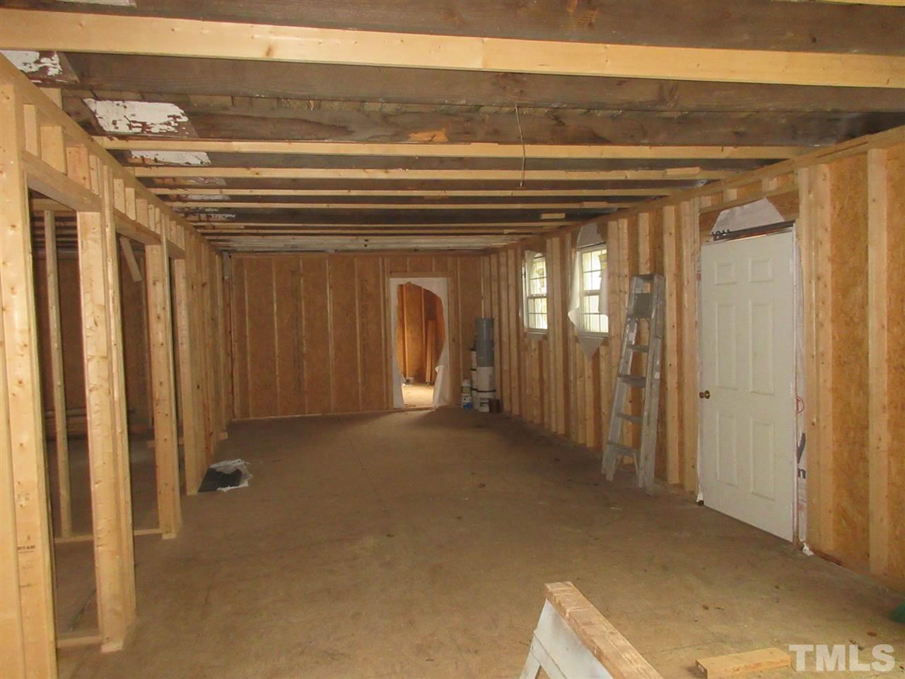 4921 Universal Drive Wake Forest, NC 27587 - Photo 2 of 15 a view of a hallway with wooden shelves