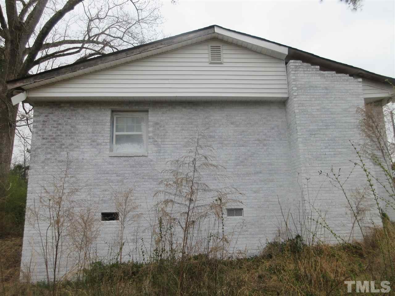 4921 Universal Drive Wake Forest, NC 27587 - Photo 12 of 15 a brick house with a small roof