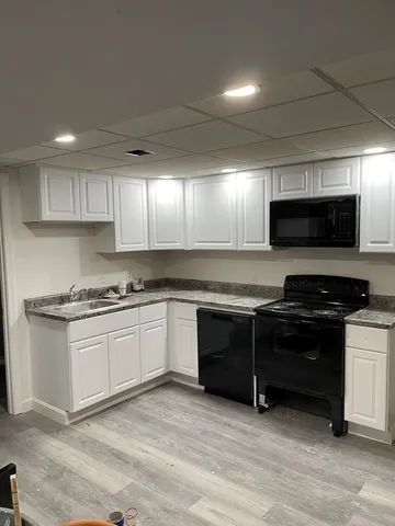 a kitchen with stainless steel appliances granite countertop a stove and a microwave