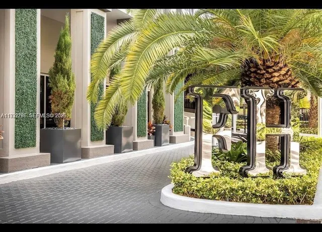 a front view of a building with garden