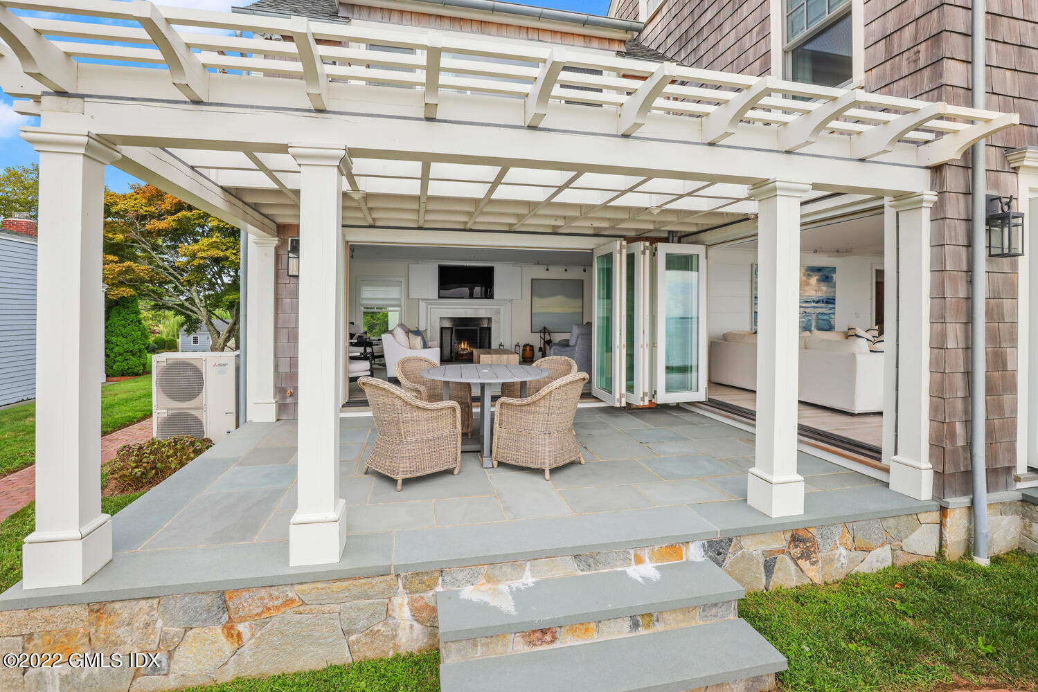 53 Shore Road Clinton, CT 06413 - Photo 15 of 32 a view of a patio with dining table and chairs