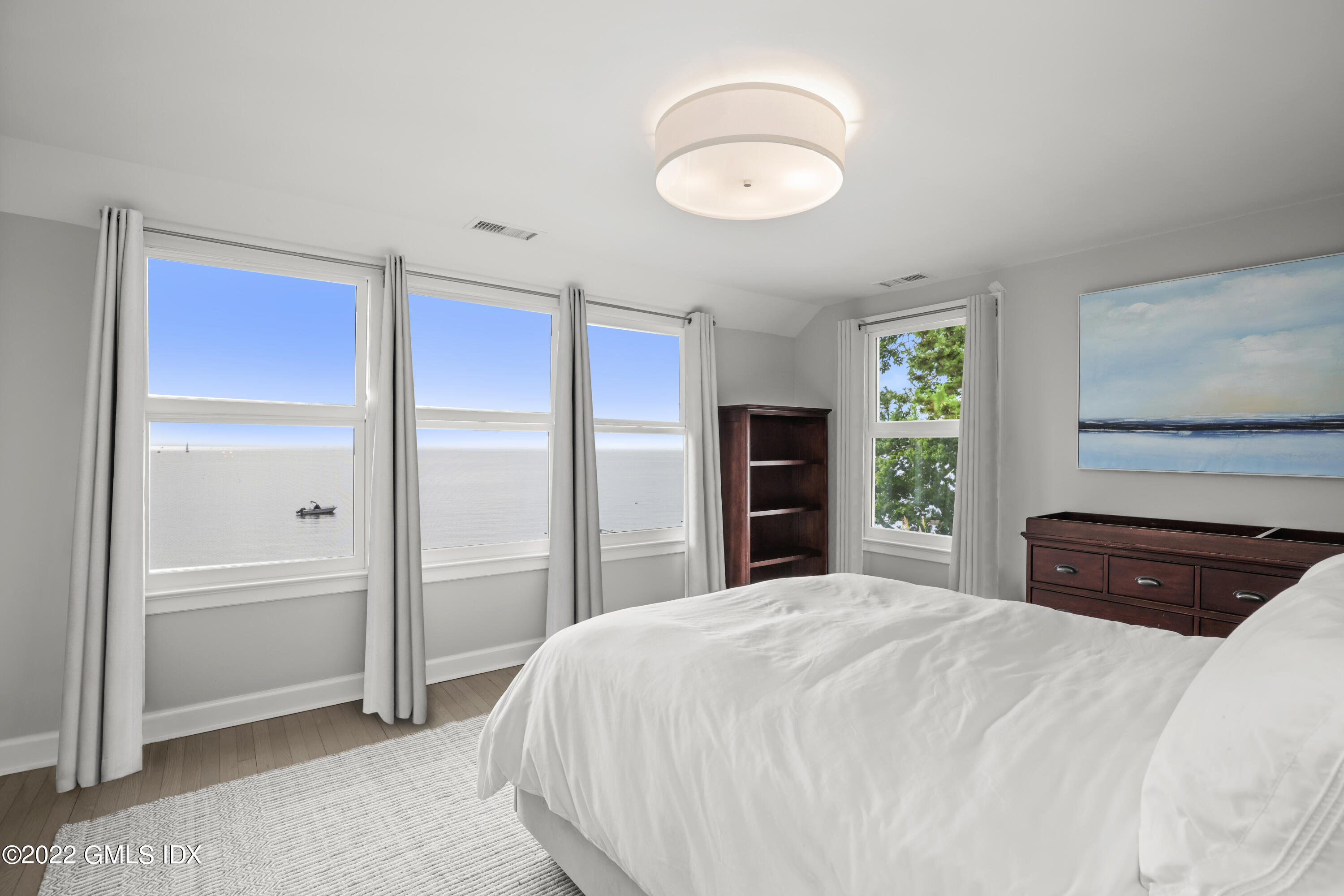 53 Shore Road Clinton, CT 06413 - Photo 16 of 32 a bedroom with a large bed and a window