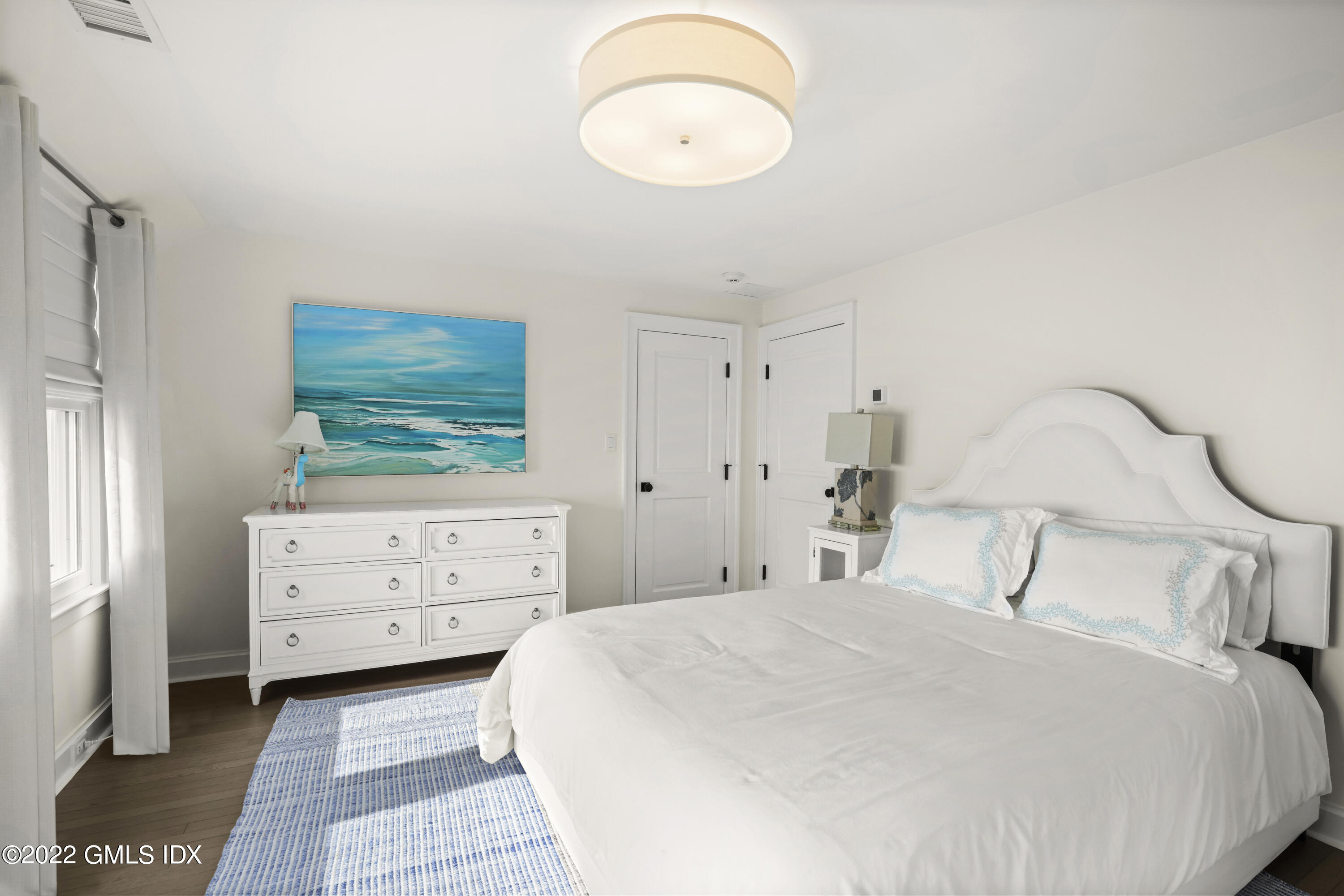 53 Shore Road Clinton, CT 06413 - Photo 18 of 32 a bedroom with a bed and a dresser