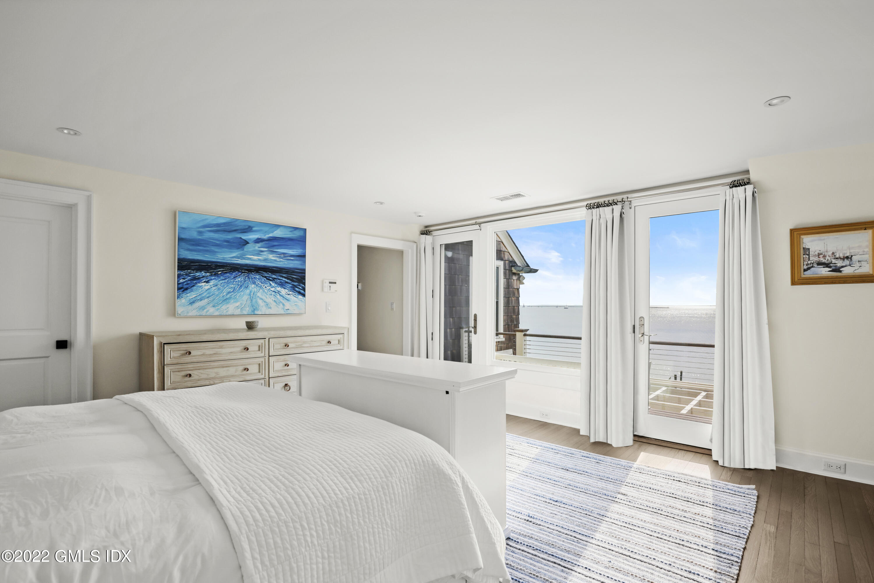 53 Shore Road Clinton, CT 06413 - Photo 20 of 32 a bedroom with a bed and a flat screen tv