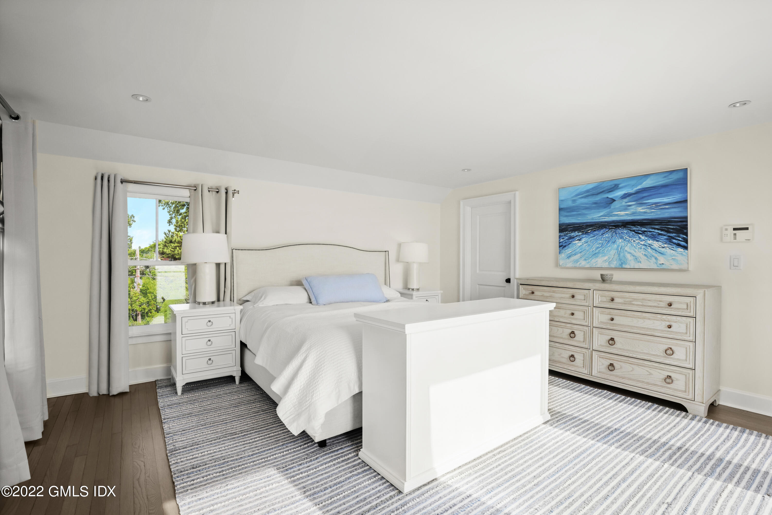 53 Shore Road Clinton, CT 06413 - Photo 21 of 32 a bedroom with a bed and a dresser