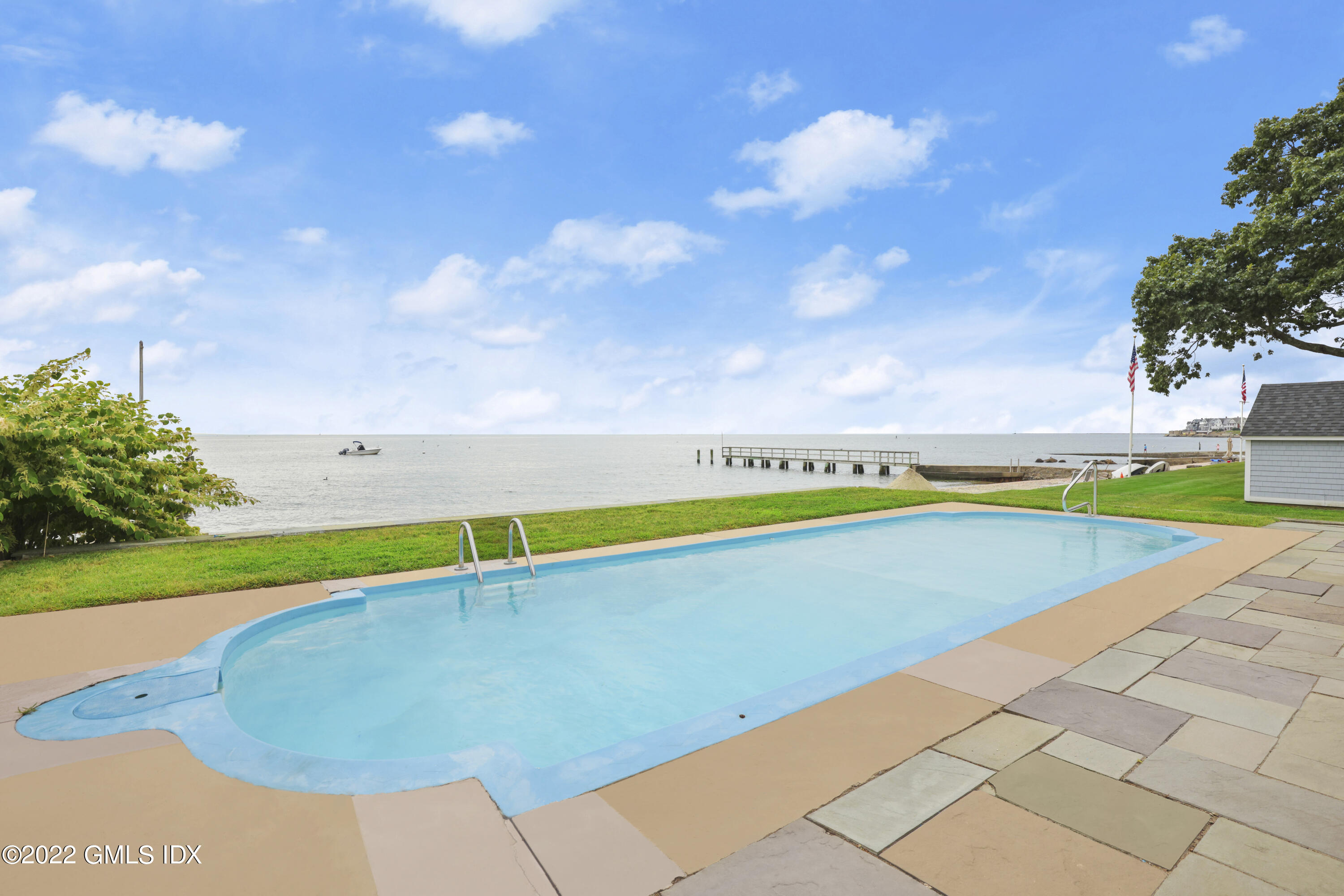 53 Shore Road Clinton, CT 06413 - Photo 23 of 32 a view of a swimming pool with an outdoor space and seating area