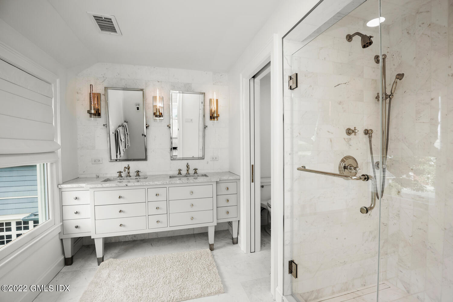 53 Shore Road Clinton, CT 06413 - Photo 8 of 32 a bathroom with a double vanity sink a mirror a shower and a bathtub