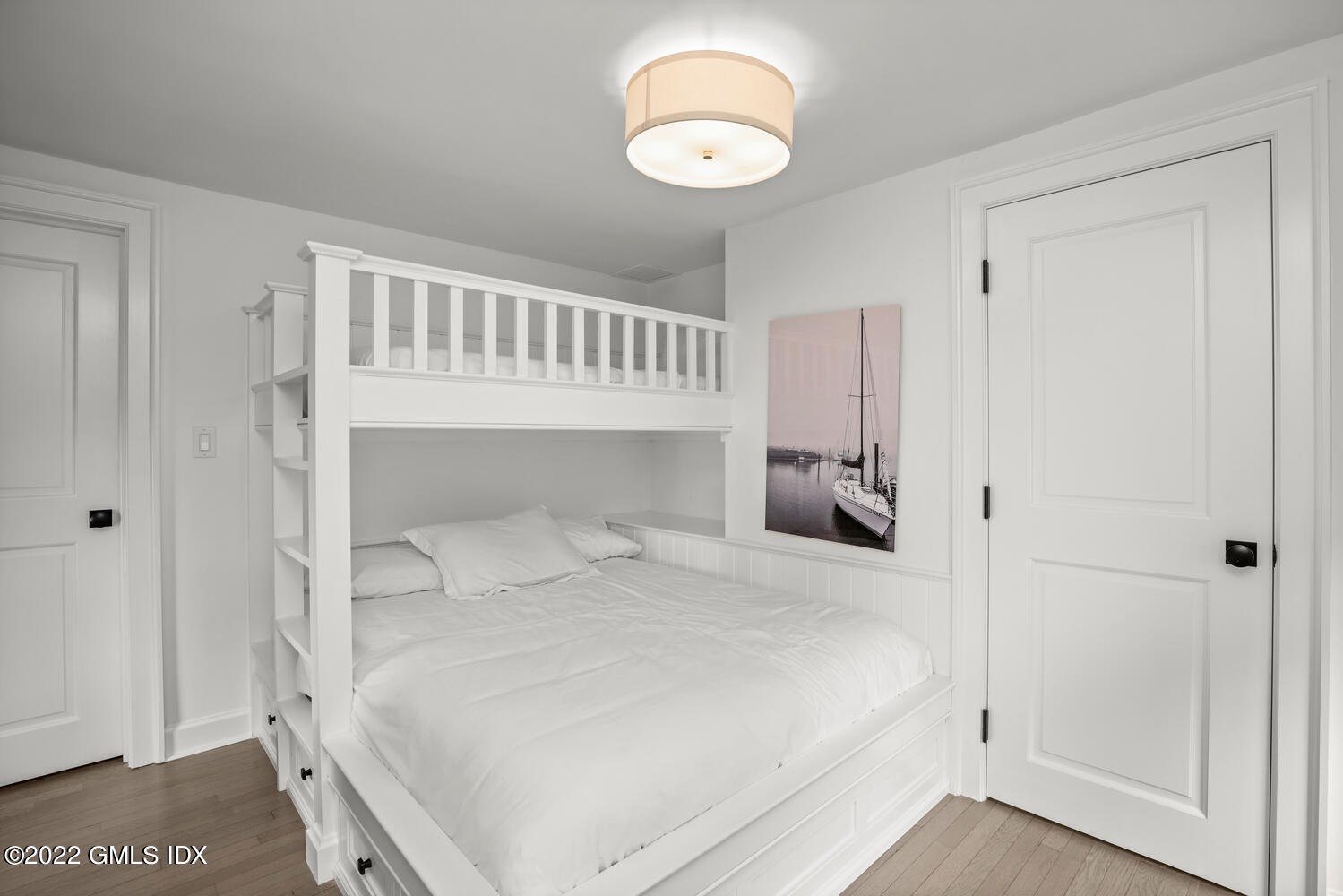 53 Shore Road Clinton, CT 06413 - Photo 9 of 32 a bedroom with a bed and cabinets