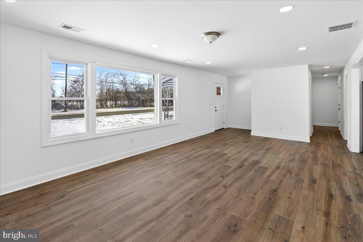 464 Sykesville Road Wrightstown, NJ 08562 - Photo 6 of 32 an empty room with wooden floor and windows