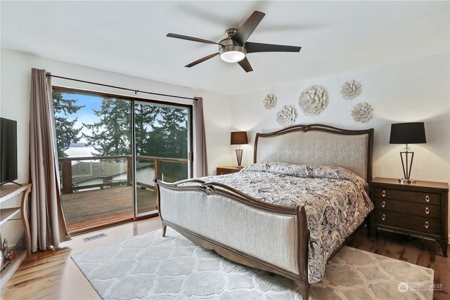 a bedroom with a bed and large window