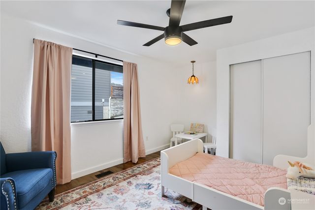 a bedroom with a bed and wooden floor