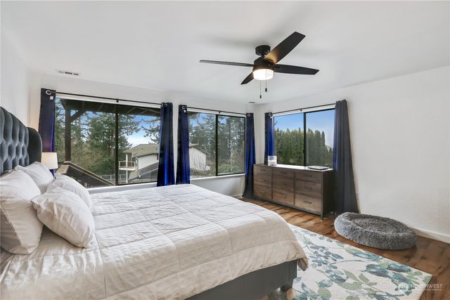 a bedroom with a large bed and a large window