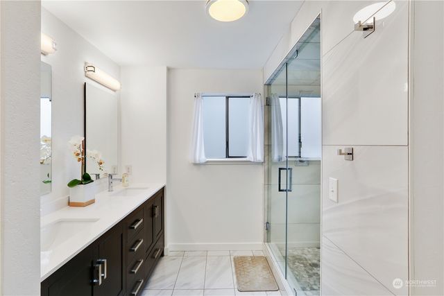 a bathroom with a double vanity sink and mirror