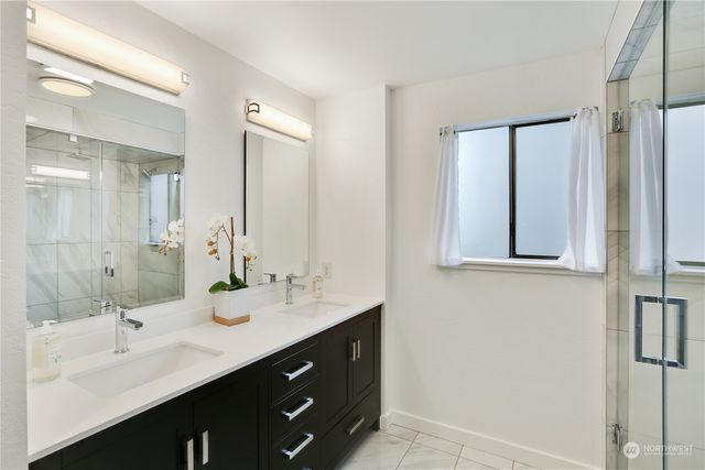 a bathroom with a double vanity sink mirror and double