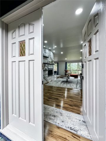 a view of living room with a floor to ceiling window and wooden floor