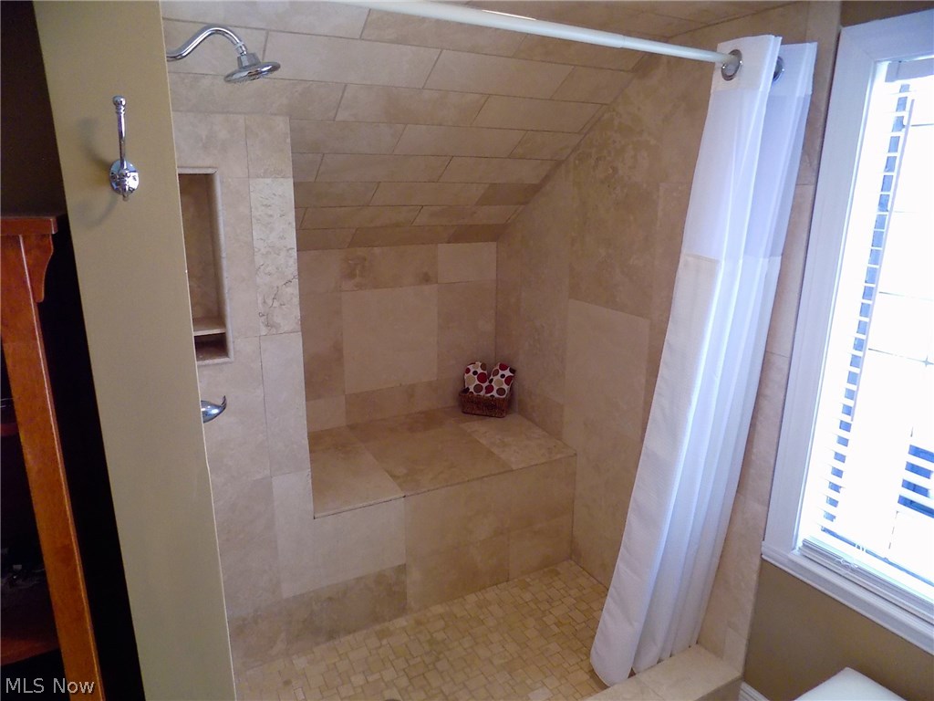 25769 Butternut Ridge Road North Olmsted, OH 44070 - Photo 11 of 35 Large travertine walk-in shower with built-in seat.
