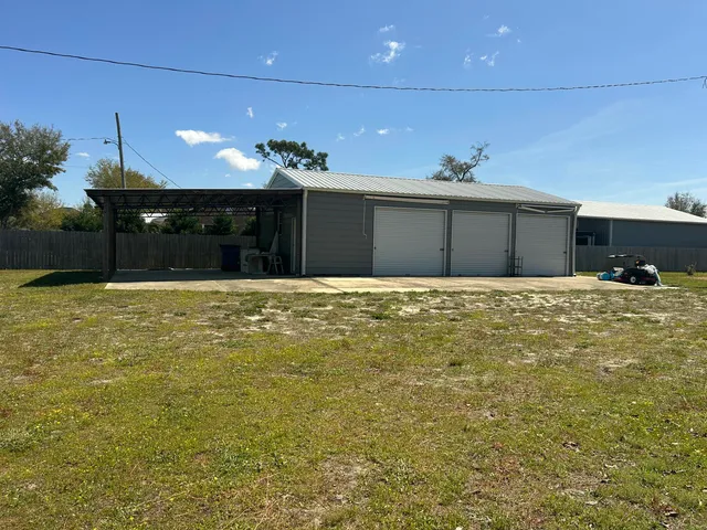 a backyard of a house with table and chairs