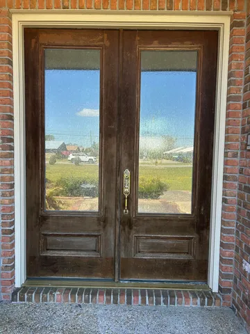 a view of a room with wooden floor and a floor to ceiling window