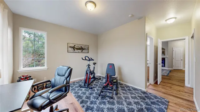 a view of a workspace with furniture and a window