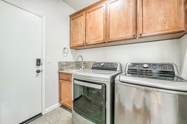 a kitchen with stainless steel appliances kitchen island granite countertop a sink and cabinets