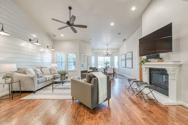 a living room with fireplace furniture and a flat screen tv