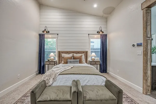 a view of a patio with a table and chairs under an umbrella with wooden fence