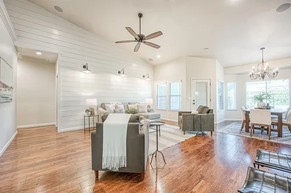 a living room with fireplace furniture and a wooden floor