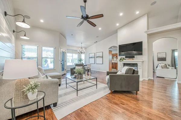a living room with furniture and a ceiling fan