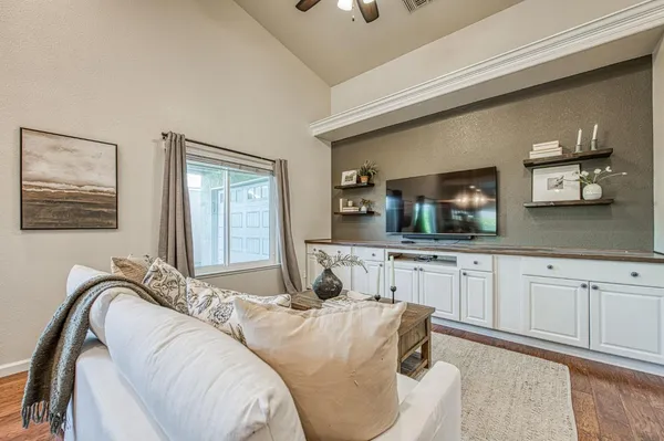 a living room with fireplace furniture and a chandelier