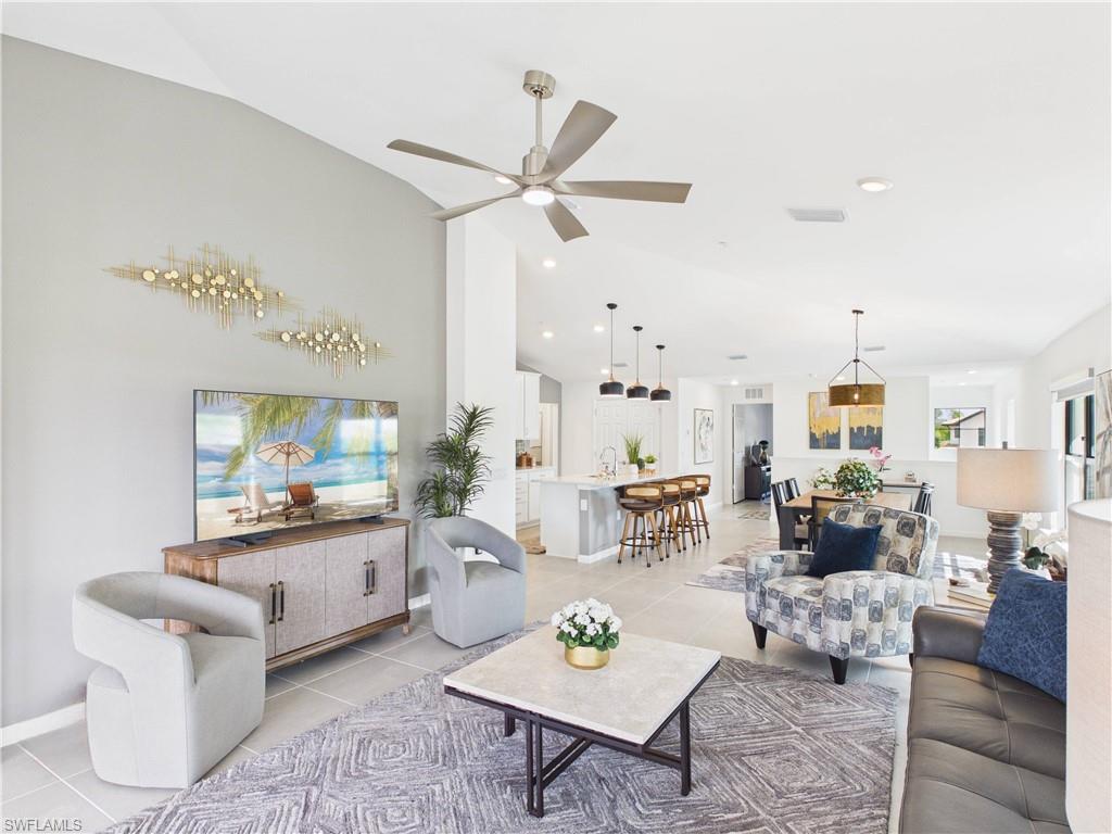 5683 Mayflower Way, Unit 908 Ave Maria, FL 34142 - Photo 18 of 37 Living room featuring light tile patterned floors, ceiling fan, and vaulted ceiling