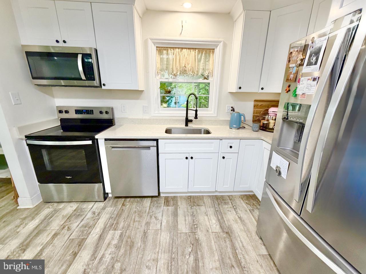2413 Shelburn Road Millville, NJ 08332 - Photo 10 of 41 a kitchen with stainless steel appliances granite countertop a stove a sink and a microwave