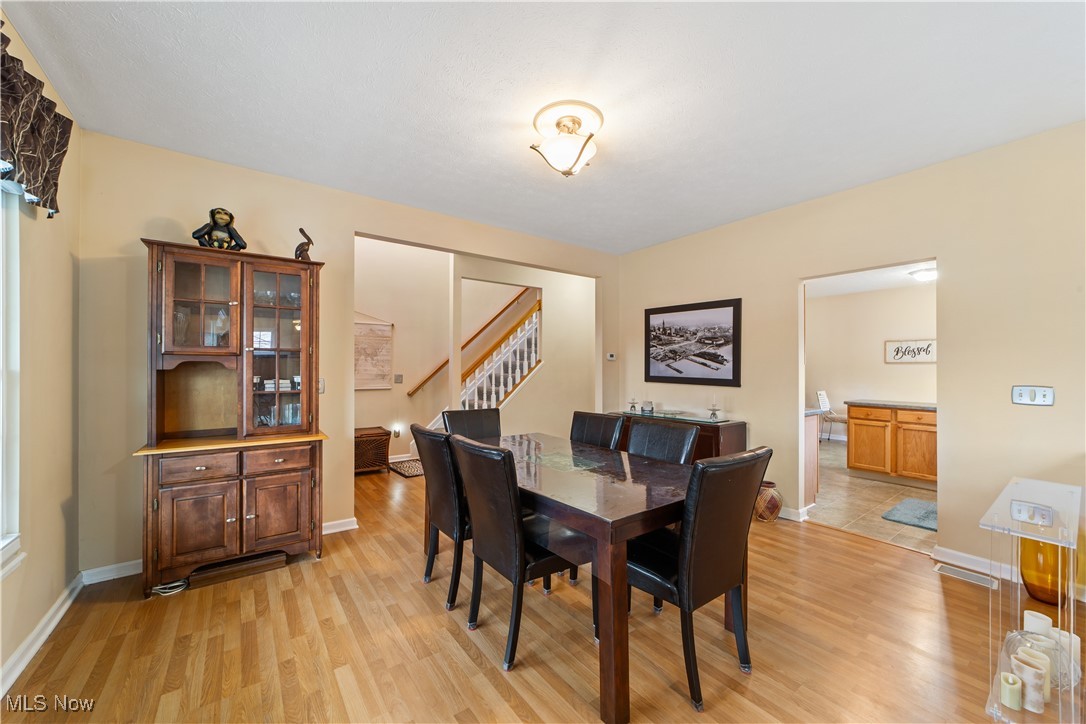 4461 Sexton Road Cleveland, OH 44105 - Photo 7 of 47 Dining area featuring stairway and light wood-style flooring
