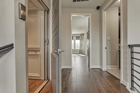 a view of a hallway with wooden floor