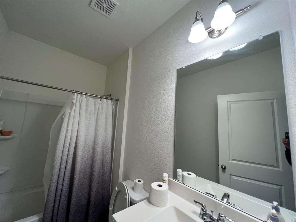 309 Redfish Lane Hutto, TX 78634 - Photo 12 of 15 a bathroom with a sink a toilet and a mirror