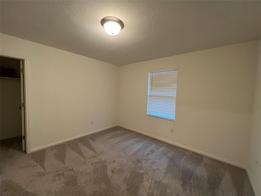 309 Redfish Lane Hutto, TX 78634 - Photo 7 of 15 an empty room with a empty space and window