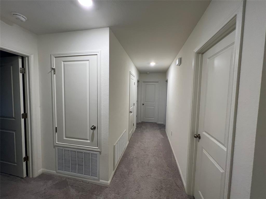 309 Redfish Lane Hutto, TX 78634 - Photo 9 of 15 a view of a hallway with a door