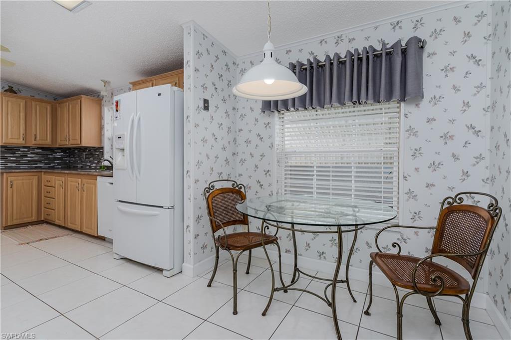 255 Riverwood Road Naples, FL 34114 - Photo 12 of 35 a view of kitchen with furniture and a refrigerator