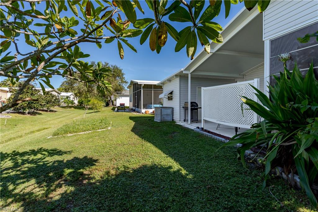 255 Riverwood Road Naples, FL 34114 - Photo 32 of 35 a view of a house with a yard