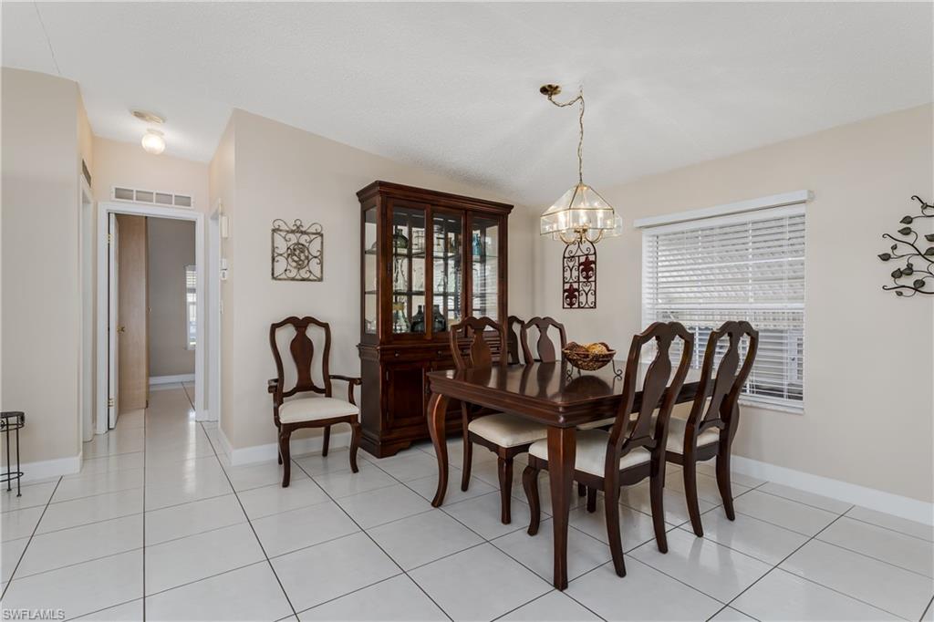 255 Riverwood Road Naples, FL 34114 - Photo 8 of 35 a view of a dining room with furniture and window