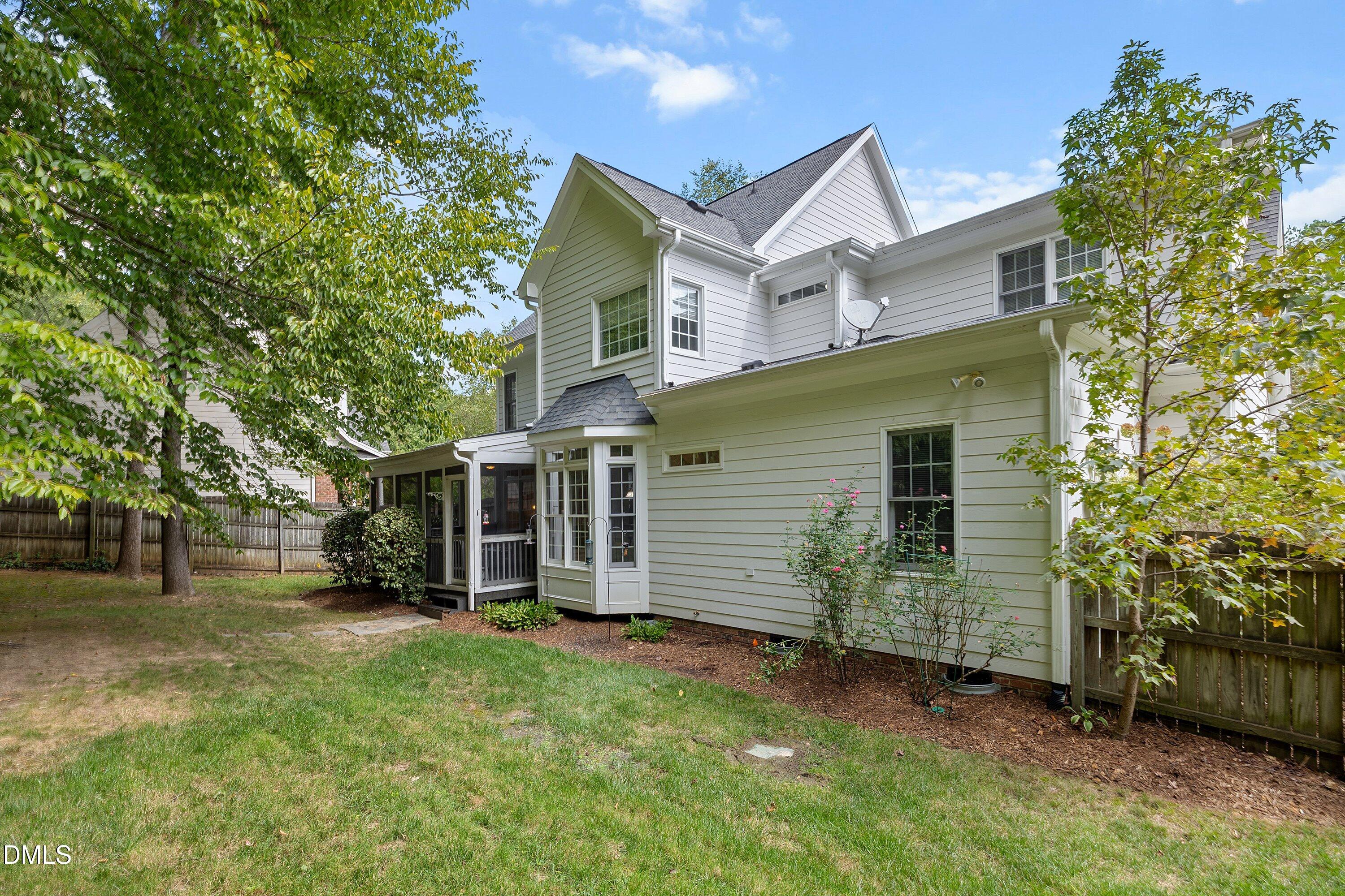3914 Sterling Ridge Lane Durham, NC 27707 - Photo 55 of 66 White siding exterior with multiple windows, screened porch, bay window, and a gabled roofline