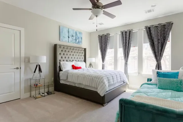 a bedroom with a bed and a chandelier