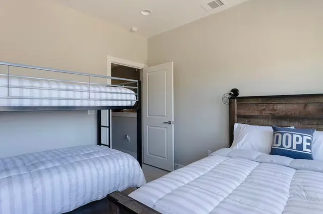 a bedroom with bed and wooden floor