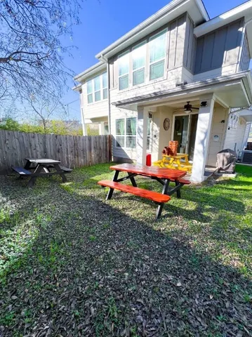 a backyard of a house with yard and outdoor seating