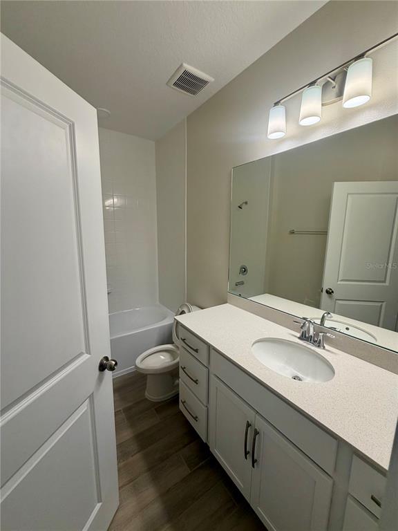5222 Ctr Lk Rnch Boulevard St. Cloud, FL 34771 - Photo 13 of 25 a bathroom with a granite countertop sink toilet and shower