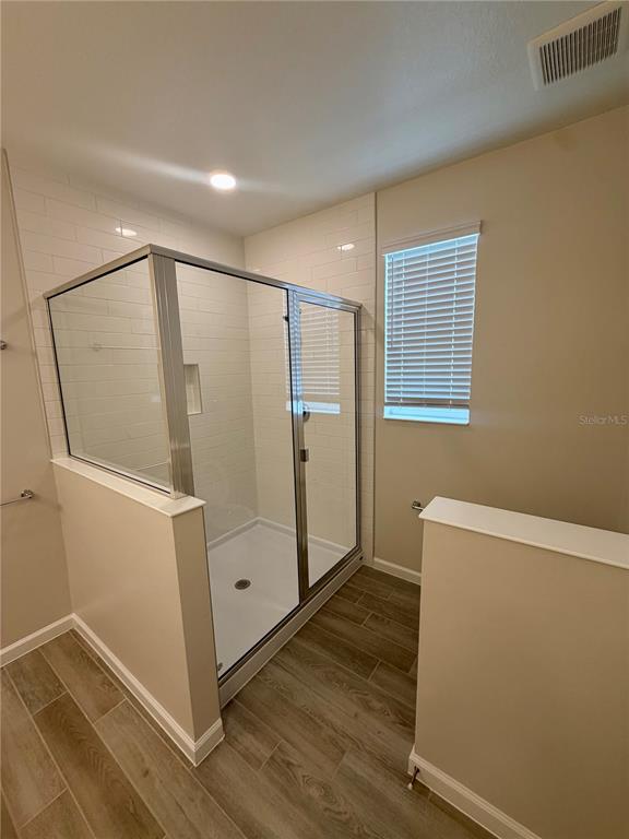 5222 Ctr Lk Rnch Boulevard St. Cloud, FL 34771 - Photo 20 of 25 a view of an empty room with wooden floor and a window